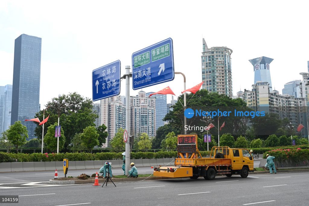 Some workers building the road near the APEC Summit of Shenzhen International Communication Center on October 11, 2026 in Shenzhen, China. (Photo by Stringer/Nexpher Images)