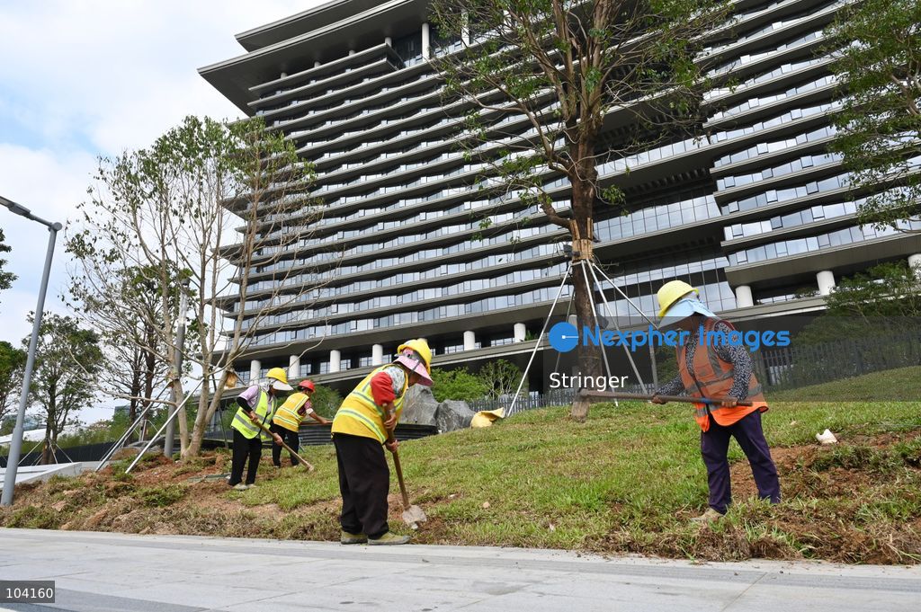 Some workers building the road of the InterContinental Shenzhen Greater Bay Area near the APEC Summit of Shenzhen International Communication Center on October 11, 2026 in Shenzhen, China. (Photo by Stringer/Nexpher Images)