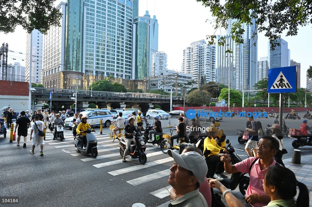 A general view showing people crossing the road on October 11, 2026 in Shenzhen, China. (Photo by Stringer/Nexpher Images)
