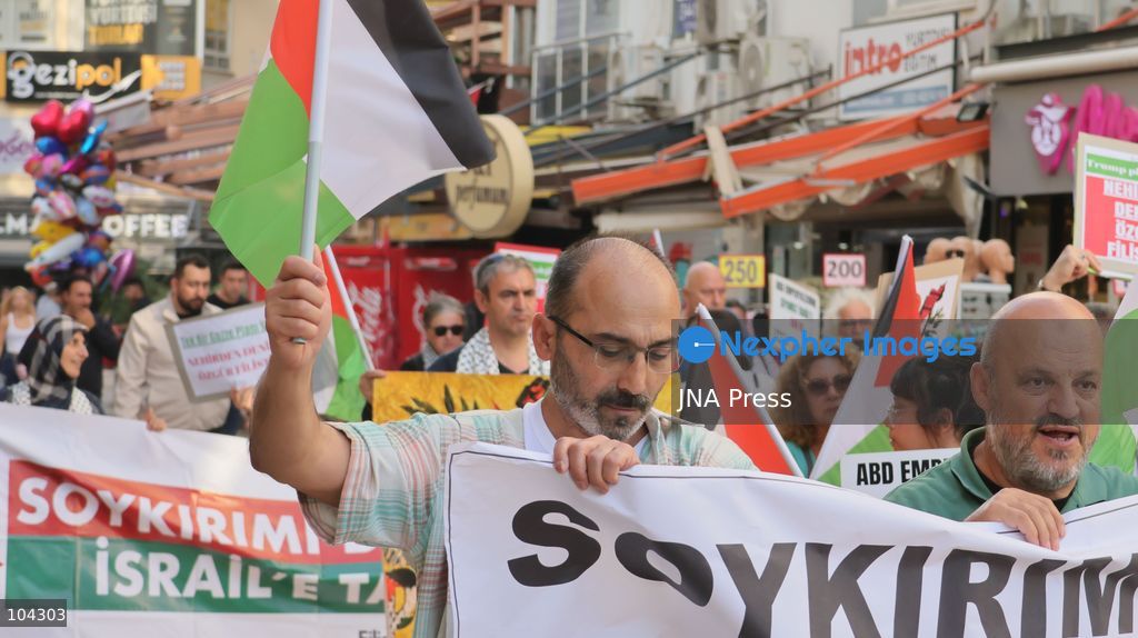 IZMIR, TURKEY, OCTOBER 11, 2026: Pro-Palestinian demonstrators gather outside the Turkan Saylan Cultural Center in Izmir during a protest organized by the local branch of the Association for the Freedom of Palestinians. Participants condemn Israeli military operations in Gaza and criticize US support for Israel, calling attention to Palestinian civilian casualties since October 7, 2023. The demonstration concludes at Gundogdu Square, where participants throw carnations into the sea in remembrance of Palestinians killed during the conflict. Photo by Turgay Kilic / JNA Press. (Photo by Turgay Kilic/JNA Press via Nexpher Images)