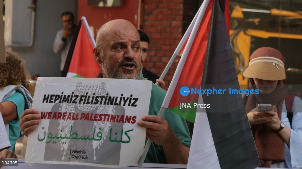 IZMIR, TURKEY, OCTOBER 11, 2026: Pro-Palestinian demonstrators gather outside the Turkan Saylan Cultural Center in Izmir during a protest organized by the local branch of the Association for the Freedom of Palestinians. Participants condemn Israeli military operations in Gaza and criticize US support for Israel, calling attention to Palestinian civilian casualties since October 7, 2023. The demonstration concludes at Gundogdu Square, where participants throw carnations into the sea in remembrance of Palestinians killed during the conflict. Photo by Turgay Kilic / JNA Press. (Photo by Turgay Kilic/JNA Press via Nexpher Images)