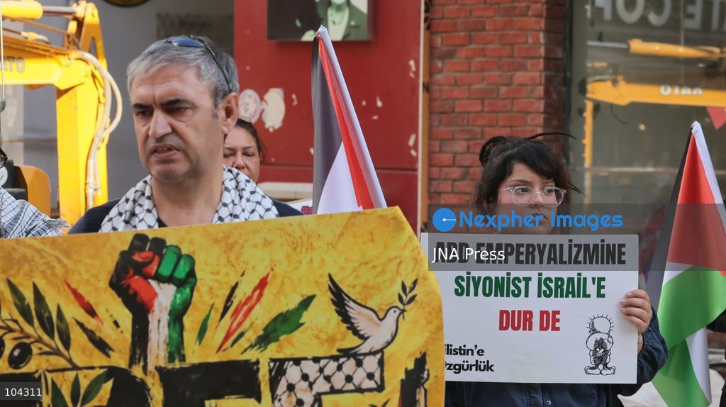 IZMIR, TURKEY, OCTOBER 11, 2026: Pro-Palestinian demonstrators gather outside the Turkan Saylan Cultural Center in Izmir during a protest organized by the local branch of the Association for the Freedom of Palestinians. Participants condemn Israeli military operations in Gaza and criticize US support for Israel, calling attention to Palestinian civilian casualties since October 7, 2023. The demonstration concludes at Gundogdu Square, where participants throw carnations into the sea in remembrance of Palestinians killed during the conflict. Photo by Turgay Kilic / JNA Press. (Photo by Turgay Kilic/JNA Press via Nexpher Images)