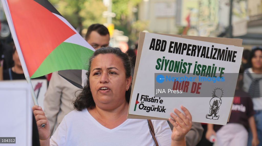 IZMIR, TURKEY, OCTOBER 11, 2026: Pro-Palestinian demonstrators gather outside the Turkan Saylan Cultural Center in Izmir during a protest organized by the local branch of the Association for the Freedom of Palestinians. Participants condemn Israeli military operations in Gaza and criticize US support for Israel, calling attention to Palestinian civilian casualties since October 7, 2023. The demonstration concludes at Gundogdu Square, where participants throw carnations into the sea in remembrance of Palestinians killed during the conflict. Photo by Turgay Kilic / JNA Press. (Photo by Turgay Kilic/JNA Press via Nexpher Images)