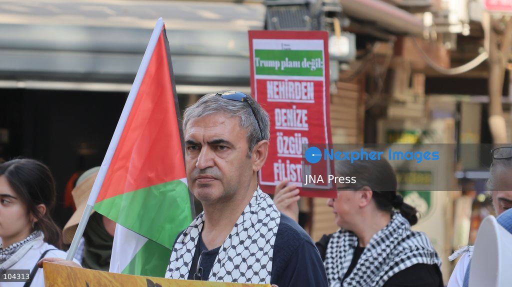 IZMIR, TURKEY, OCTOBER 11, 2026: Pro-Palestinian demonstrators gather outside the Turkan Saylan Cultural Center in Izmir during a protest organized by the local branch of the Association for the Freedom of Palestinians. Participants condemn Israeli military operations in Gaza and criticize US support for Israel, calling attention to Palestinian civilian casualties since October 7, 2023. The demonstration concludes at Gundogdu Square, where participants throw carnations into the sea in remembrance of Palestinians killed during the conflict. Photo by Turgay Kilic / JNA Press. (Photo by Turgay Kilic/JNA Press via Nexpher Images)