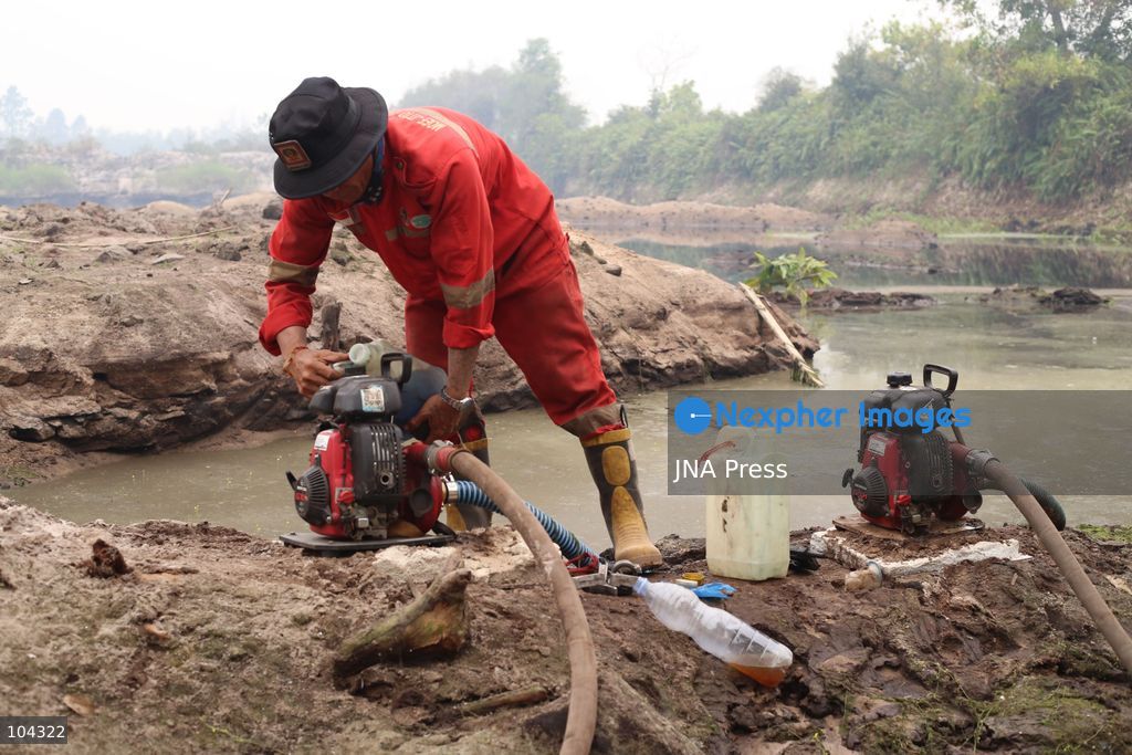PALANGKA RAYA, CENTRAL KALIMANTAN, INDONESIA, OCTOBER 11, 2026: Members of Indonesia's Manggala Agni forest fire brigade work to extinguish a forest fire in the Sebangau area of Palangka Raya, Central Kalimantan. The firefighting team has been responding to fires affecting forests and community land in the region during the dry season. Photo by Regina Safri / JNA Press. (Photo by Regina Safri/JNA Press via Nexpher Images)