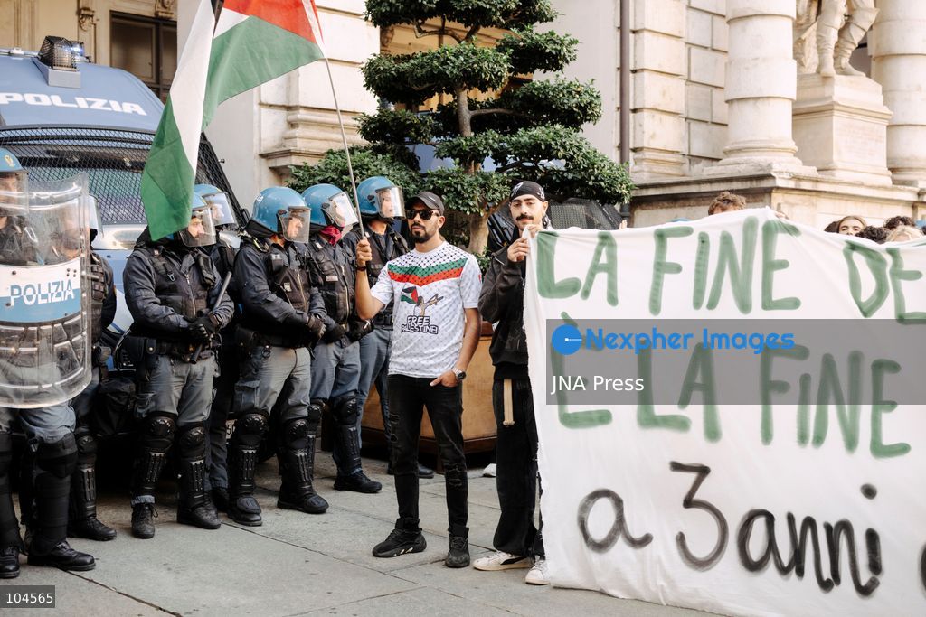 TURIN, ITALY, OCTOBER 10, 2026: A protester holds a Palestinian flag a few meters from the police line in front of Turin City Hall during the regional demonstration in support of Palestine. Photo by Luca Prestia / JNA Press (Photo by Luca Prestia/JNA Press via Nexpher Images)