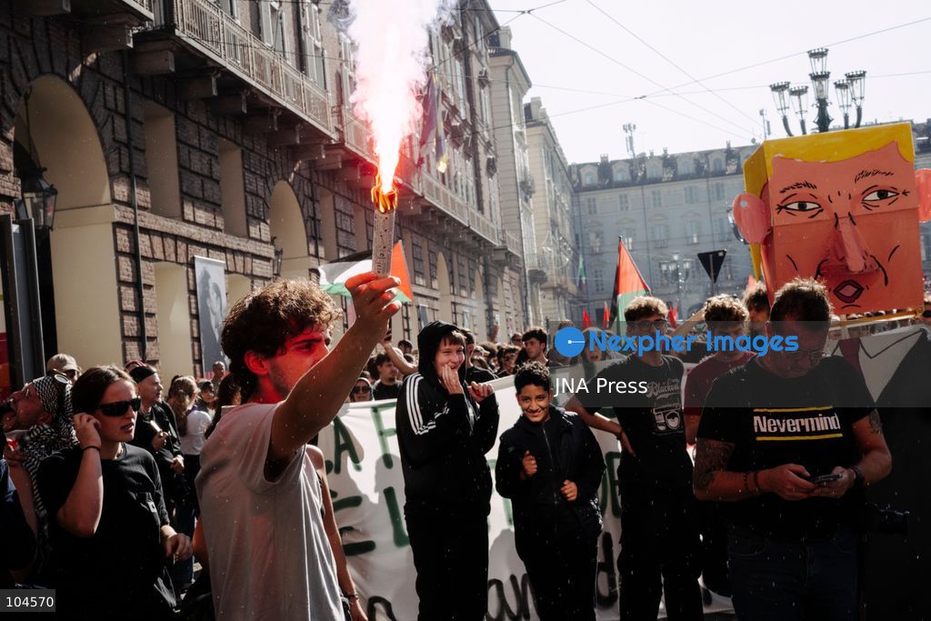 TURIN, ITALY, OCTOBER 10, 2026: A protester celebrates holding a red smoke bomb as the march enters Piazza Castello in Turin, Italy, a square police had initially blocked, preventing the start of the demonstration in support of Palestine. Photo by Luca Prestia / JNA Press (Photo by Luca Prestia/JNA Press via Nexpher Images)