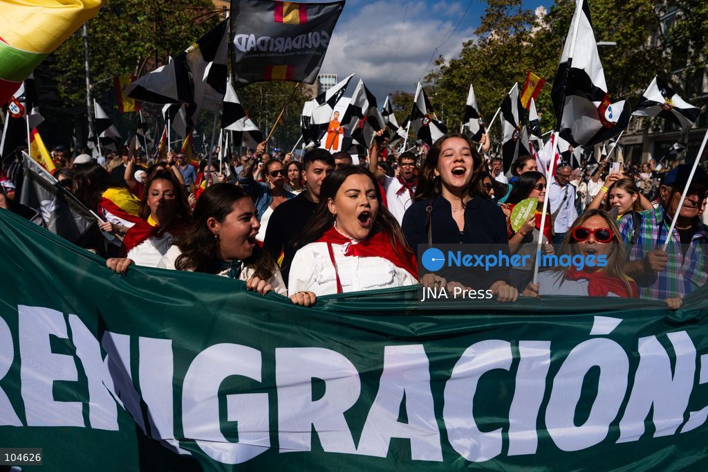 BARCELONA, SPAIN, OCTOBER 12, 2026: Demonstrators march along Passeig de Gracia in central Barcelona, waving Spanish flags during a rally marking Spain's National Day. Organised by the Unidos por Ceuta platform, the march expresses support for Ceuta and Spanish national unity. Participants include representatives and supporters of the Partido Popular (PP) and Vox, as well as members of the far-right group Nucleo Nacional. Photo by Marc Asensio Clupes / JNA Press. (Photo by Marc Asensio Clupes/JNA Press via Nexpher Images)