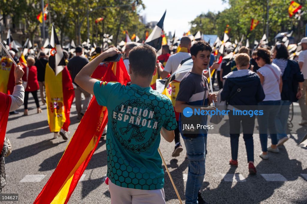 BARCELONA, SPAIN, OCTOBER 12, 2026: Demonstrators march along Passeig de Gracia in central Barcelona, waving Spanish flags during a rally marking Spain's National Day. Organised by the Unidos por Ceuta platform, the march expresses support for Ceuta and Spanish national unity. Participants include representatives and supporters of the Partido Popular (PP) and Vox, as well as members of the far-right group Nucleo Nacional. Photo by Marc Asensio Clupes / JNA Press. (Photo by Marc Asensio Clupes/JNA Press via Nexpher Images)