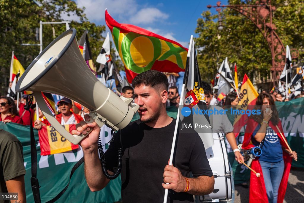 BARCELONA, SPAIN, OCTOBER 12, 2026: Demonstrators march along Passeig de Gracia in central Barcelona, waving Spanish flags during a rally marking Spain's National Day. Organised by the Unidos por Ceuta platform, the march expresses support for Ceuta and Spanish national unity. Participants include representatives and supporters of the Partido Popular (PP) and Vox, as well as members of the far-right group Nucleo Nacional. Photo by Marc Asensio Clupes / JNA Press. (Photo by Marc Asensio Clupes/JNA Press via Nexpher Images)
