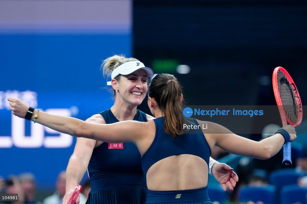 Gabriela Dabrowski of Canada and Luisa Stefani of Brazil celebrates winning against Zhang Shuai of China and Katerina Siniakova of the Czech Republic 2-0 in the women's doubles final at the Diamond Court of the National Tennis Center in Beijing, China, on October 11, 2026. Stefani (R) and Dabrowski are seen discussing their serving tactics. (Photo by Peter Li/Nexpher Images)