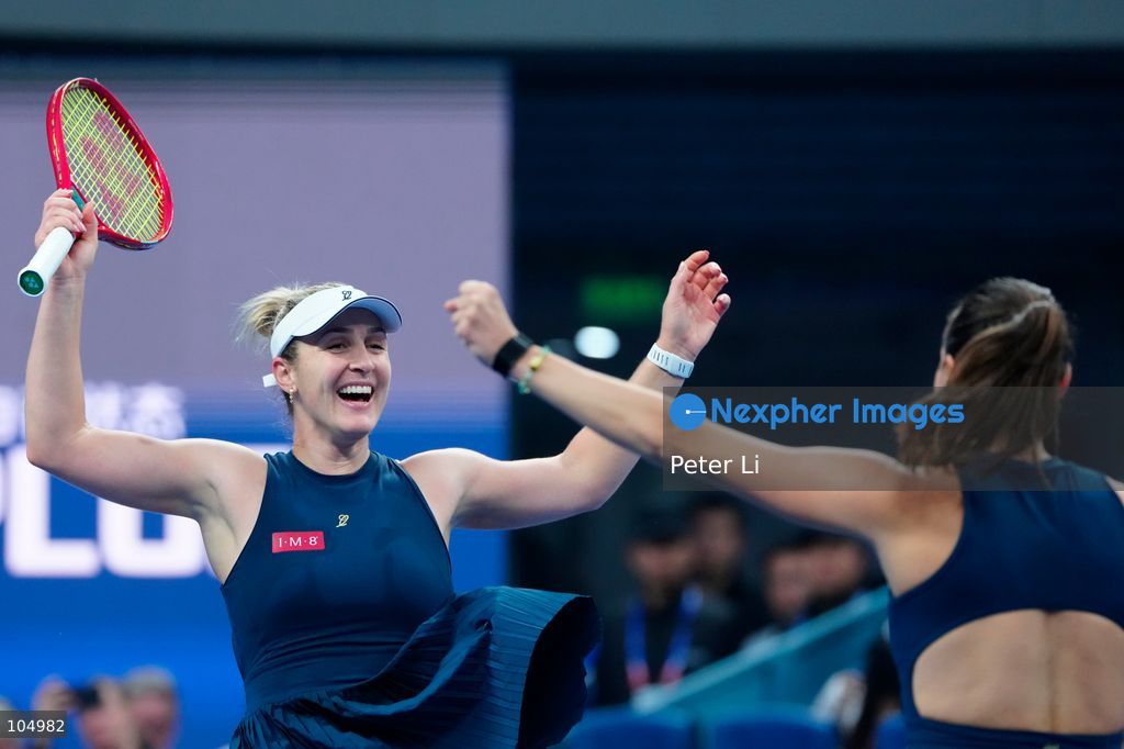 Gabriela Dabrowski of Canada and Luisa Stefani of Brazil celebrates winning against Zhang Shuai of China and Katerina Siniakova of the Czech Republic 2-0 in the women's doubles final at the Diamond Court of the National Tennis Center in Beijing, China, on October 11, 2026. Stefani (R) and Dabrowski are seen discussing their serving tactics. (Photo by Peter Li/Nexpher Images)