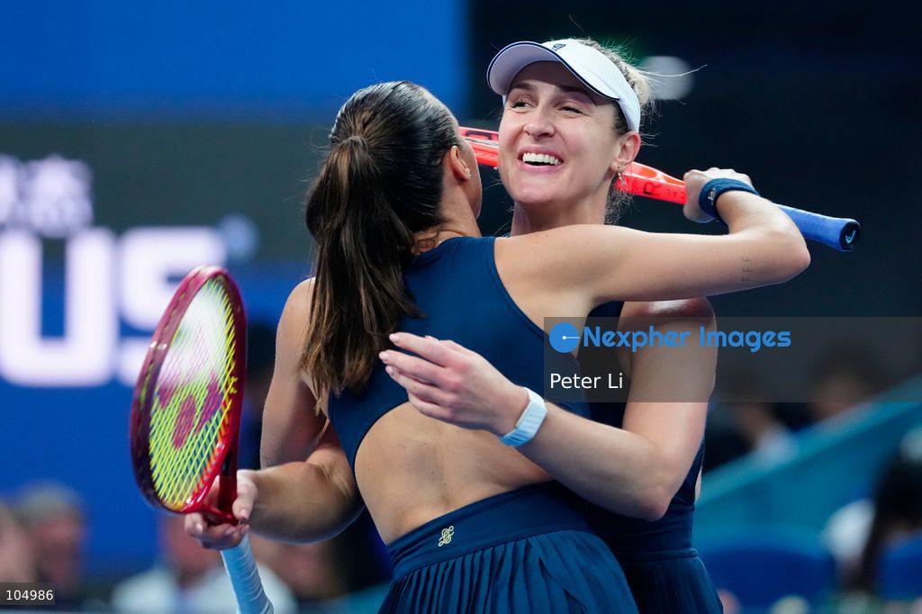 Gabriela Dabrowski of Canada and Luisa Stefani of Brazil celebrates winning against Zhang Shuai of China and Katerina Siniakova of the Czech Republic 2-0 in the women's doubles final at the Diamond Court of the National Tennis Center in Beijing, China, on October 11, 2026. Stefani (R) and Dabrowski are seen discussing their serving tactics. (Photo by Peter Li/Nexpher Images)
