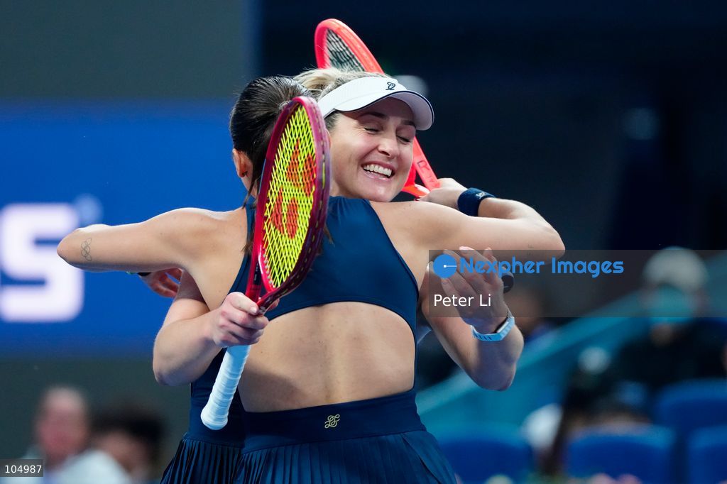 Gabriela Dabrowski of Canada and Luisa Stefani of Brazil celebrates winning against Zhang Shuai of China and Katerina Siniakova of the Czech Republic 2-0 in the women's doubles final at the Diamond Court of the National Tennis Center in Beijing, China, on October 11, 2026. Stefani (R) and Dabrowski are seen discussing their serving tactics. (Photo by Peter Li/Nexpher Images)