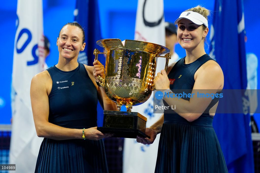 Gabriela Dabrowski of Canada and Luisa Stefani of Brazil pose with the trophy after winning against Zhang Shuai of China and Katerina Siniakova of the Czech Republic 2-0 in the women's doubles final at the Diamond Court of the National Tennis Center in Beijing, China, on October 11, 2026. Stefani (R) and Dabrowski are seen discussing their serving tactics. (Photo by Peter Li/Nexpher Images)