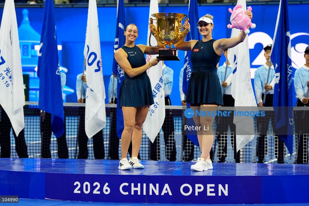 Gabriela Dabrowski of Canada and Luisa Stefani of Brazil pose with the trophy after winning against Zhang Shuai of China and Katerina Siniakova of the Czech Republic 2-0 in the women's doubles final at the Diamond Court of the National Tennis Center in Beijing, China, on October 11, 2026. Stefani (R) and Dabrowski are seen discussing their serving tactics. (Photo by Peter Li/Nexpher Images)