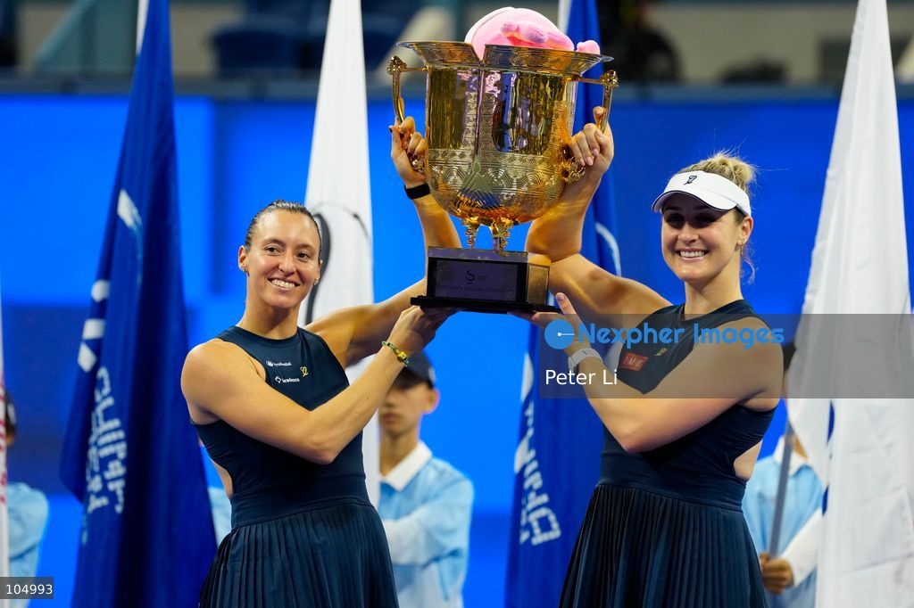 Gabriela Dabrowski of Canada and Luisa Stefani of Brazil pose with the trophy after winning  against Zhang Shuai of China and Katerina Siniakova of the Czech Republic 2-0 in the women's doubles final at the Diamond Court of the National Tennis Center in Beijing, China, on October 11, 2026. Stefani (R) and Dabrowski are seen discussing their serving tactics. (Photo by Peter Li/Nexpher Images)