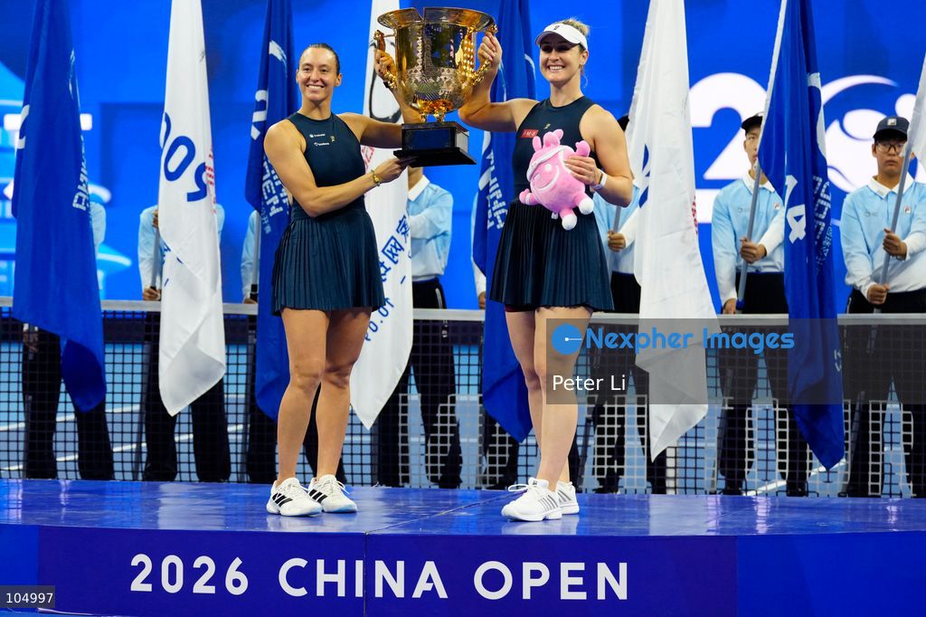 Gabriela Dabrowski of Canada and Luisa Stefani of Brazil pose with the trophy after winning against Zhang Shuai of China and Katerina Siniakova of the Czech Republic 2-0 in the women's doubles final at the Diamond Court of the National Tennis Center in Beijing, China, on October 11, 2026. Stefani (R) and Dabrowski are seen discussing their serving tactics. (Photo by Peter Li/Nexpher Images)