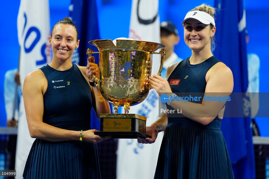 Gabriela Dabrowski of Canada and Luisa Stefani of Brazil pose with the trophy after winning  against Zhang Shuai of China and Katerina Siniakova of the Czech Republic 2-0 in the women's doubles final at the Diamond Court of the National Tennis Center in Beijing, China, on October 11, 2026. Stefani (R) and Dabrowski are seen discussing their serving tactics. (Photo by Peter Li/Nexpher Images)