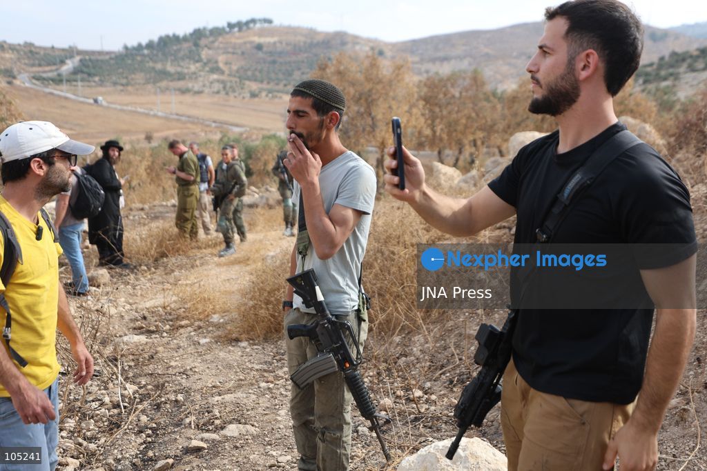 IDHNA, WEST BANK, PALESTINE, OCTOBER 13, 2026: Israeli soldiers and settlers prevent Palestinians and activists from harvesting olives in Idhna, west of Hebron, in the occupied West Bank. Israeli forces order the harvesters and activists to leave the area. Photo by Mosab Shawer / JNA Press. (Photo by Mosab shawer/JNA Press via Nexpher Images)