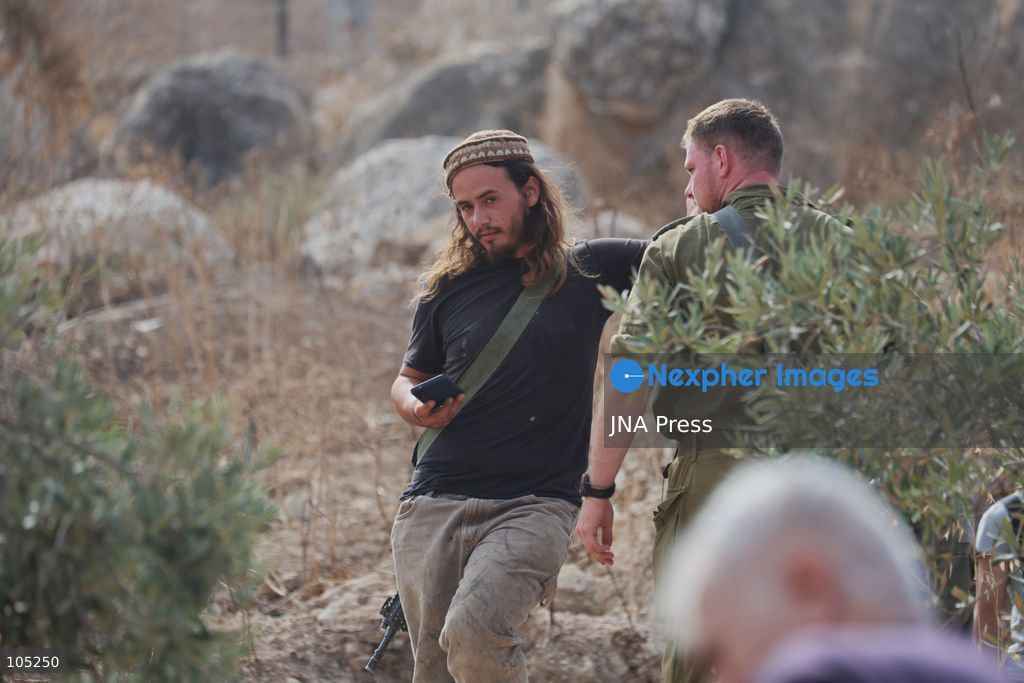 IDHNA, WEST BANK, PALESTINE, OCTOBER 13, 2026: Israeli soldiers and settlers prevent Palestinians and activists from harvesting olives in Idhna, west of Hebron, in the occupied West Bank. Israeli forces order the harvesters and activists to leave the area. Photo by Mosab Shawer / JNA Press. (Photo by Mosab shawer/JNA Press via Nexpher Images)