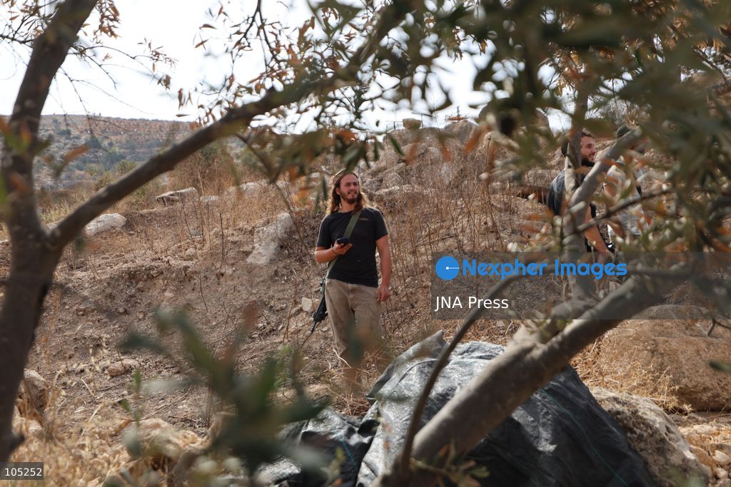 IDHNA, WEST BANK, PALESTINE, OCTOBER 13, 2026: Israeli soldiers and settlers prevent Palestinians and activists from harvesting olives in Idhna, west of Hebron, in the occupied West Bank. Israeli forces order the harvesters and activists to leave the area. Photo by Mosab Shawer / JNA Press. (Photo by Mosab shawer/JNA Press via Nexpher Images)