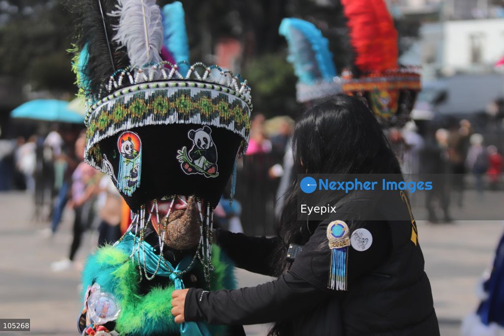 A Pilgrim wearing an elaborate, colorful Chinelo costume stands in the courtyard of the Basilica of Our Lady of Guadalupe during a religious pilgrimage . Faithful from across the country gathered at the national shrine to mark the 50th anniversary of the dedication and opening of the New Basilica, which was inaugurated. on October 12, 2026 in Mexico City, Mexico. (Photo by Carlos Santiago/ Eyepix Group) (Photo by Carlos Santiago/ Eyepix Group/Eyepix via Nexpher Images)