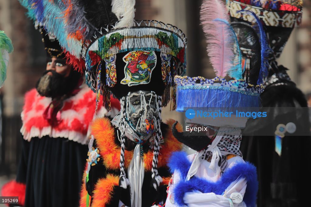 Pilgrims wearing an elaborate, colorful Chinelo costume stands in the courtyard of the Basilica of Our Lady of Guadalupe during a religious pilgrimage . Faithful from across the country gathered at the national shrine to mark the 50th anniversary of the dedication and opening of the New Basilica, which was inaugurated. on October 12, 2026 in Mexico City, Mexico. (Photo by Carlos Santiago/ Eyepix Group) (Photo by Carlos Santiago/  Eyepix Group/Eyepix via Nexpher Images)