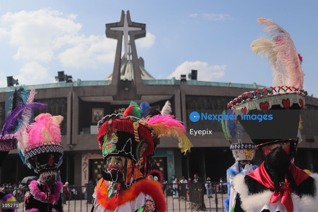 Pilgrims wearing an elaborate, colorful Chinelo costume stands in the courtyard of the Basilica of Our Lady of Guadalupe during a religious pilgrimage . Faithful from across the country gathered at the national shrine to mark the 50th anniversary of the dedication and opening of the New Basilica, which was inaugurated. on October 12, 2026 in Mexico City, Mexico. (Photo by Carlos Santiago/ Eyepix Group) (Photo by Carlos Santiago/ Eyepix Group/Eyepix via Nexpher Images)