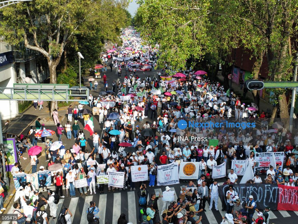 MEXICO CITY, MEXICO, OCTOBER 13, 2026: Workers from the Mexican Social Security Institute (IMSS) march through Mexico City to demand a 10 percent pay increase, improved working conditions and adequate supplies of medicines and medical equipment. The demonstration comes ahead of a union vote on a proposed pay and benefits package. Photo by Carlos Santiago / JNA Press. (Photo by Carlos Santiago/JNA Press via Nexpher Images)
