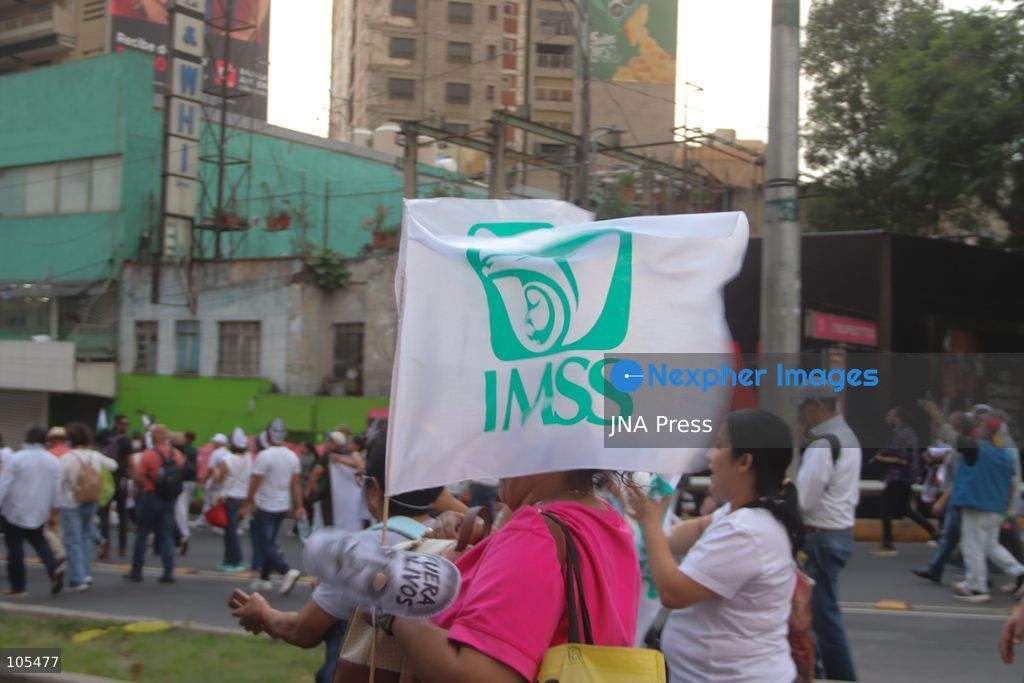 MEXICO CITY, MEXICO, OCTOBER 13, 2026: Workers from the Mexican Social Security Institute (IMSS) march through Mexico City to demand a 10 percent pay increase, improved working conditions and adequate supplies of medicines and medical equipment. The demonstration comes ahead of a union vote on a proposed pay and benefits package. Photo by Carlos Santiago / JNA Press. (Photo by Carlos Santiago/JNA Press via Nexpher Images)