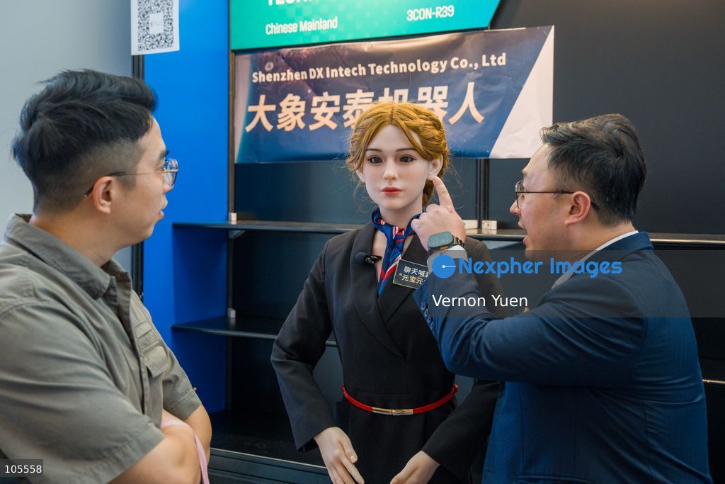 People looking at a bionic humanoid head robot at the Hong Kong Electronics Fair on October 14, 2026 in Hong Kong. (Photo by Vernon Yuen/Nexpher Images)