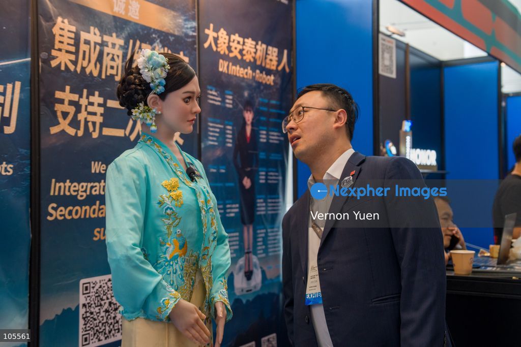 People looking at a bionic humanoid head robot at the Hong Kong Electronics Fair on October 14, 2026 in Hong Kong. (Photo by Vernon Yuen/Nexpher Images)