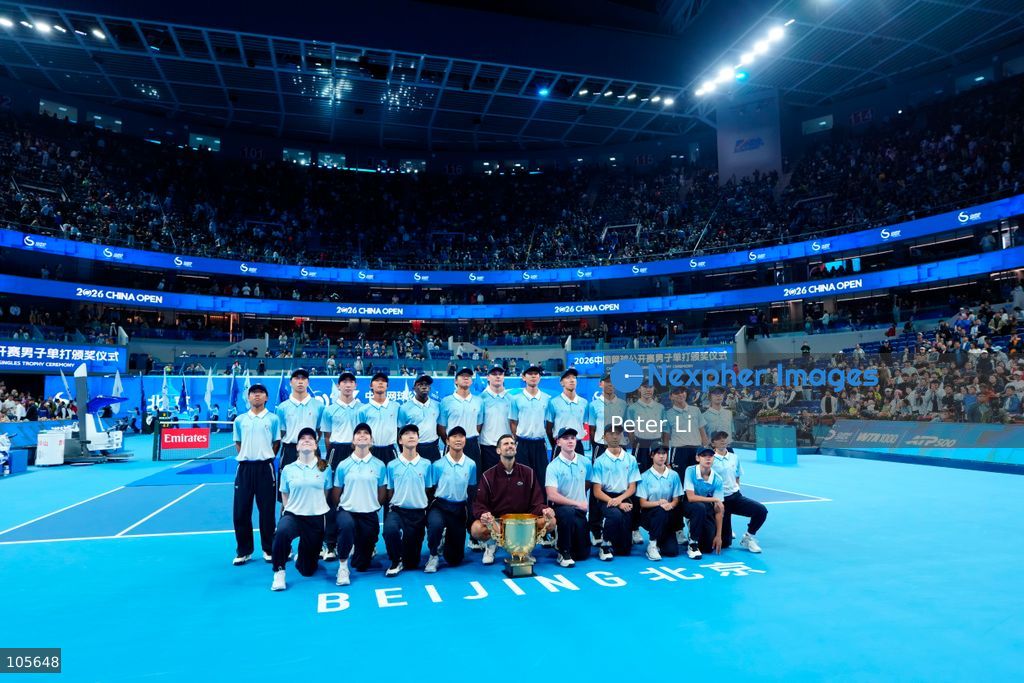 Novak Djokovic of Serbia poses with the trophy after winning against Alex De Minaur of Australia during their Men's Singles final match on day seven of China Open at the National Tennis Center on October 6, 2026 in Beijing, China. (Photo by Peter Li/Nexpher Images)