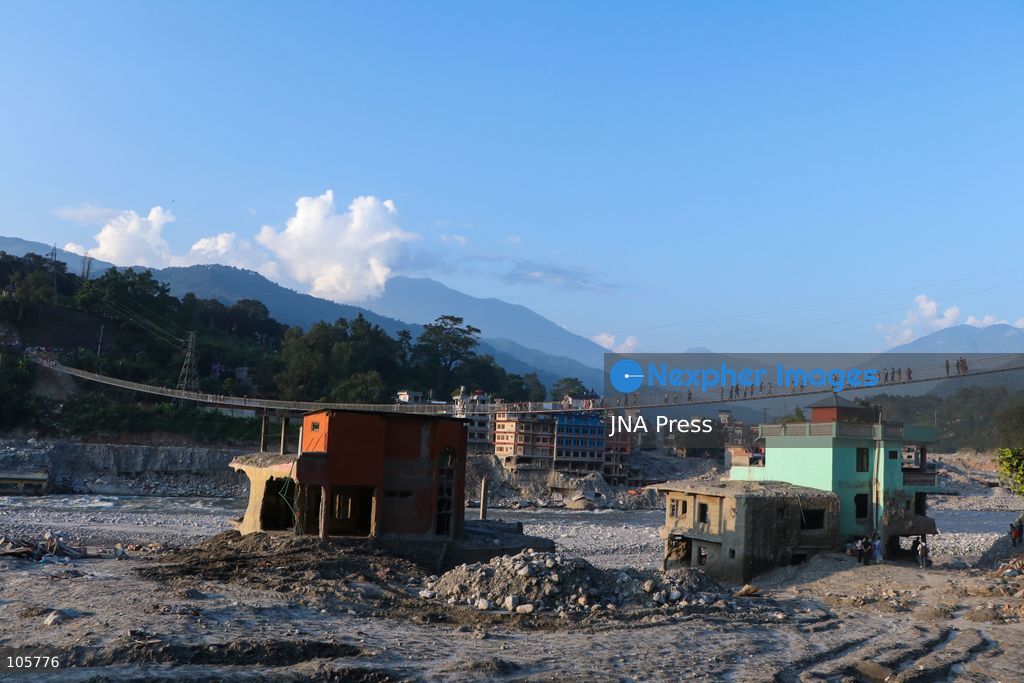 NUWAKOT, NEPAL, OCTOBER 14, 2026: Residents cross a newly built suspension bridge over the Trishuli River in Nuwakot, restoring access between communities affected by flash floods. Flooding destroyed bridges and damaged roads in the district, disrupting travel and access to essential services. Photo by Shankar Bhujel / JNA Press (Photo by Shankar Bhujel/JNA Press via Nexpher Images)