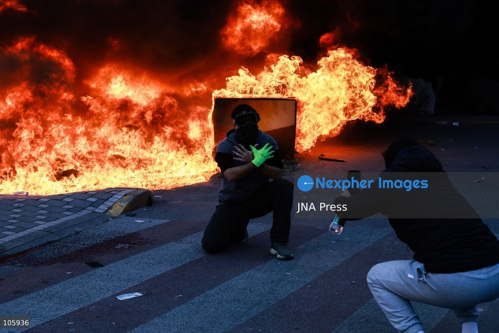 TIRANA, ALBANIA, OCTOBER 14, 2026: Demonstrators clash with riot police during student-led protests over rising education costs, university conditions and alleged corruption in Tirana. Fires damage the Ministry of Education and bank premises as protesters throw stones and other objects, while police use tear gas and water cannons. Photo by Vlasov Sulaj / JNA Press. (Photo by Vlasov Sulaj/JNA Press via Nexpher Images)