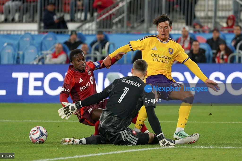 Richie Laryea #22, Luka Gavran #01 of Toronto FC and Harvey Sarajian #23 of Orlando City SC battle for the ball during the Major League Soccer Match between Toronto FC and Orlando City SC at BMO Field Stadium. on October 14, 2026 in Toronto, Canada. (Photo by Leonardo Ramirez/ Eyepix Group) (Photo by Leonardo Ramirez / Eyepix Group/Eyepix via Nexpher Images)