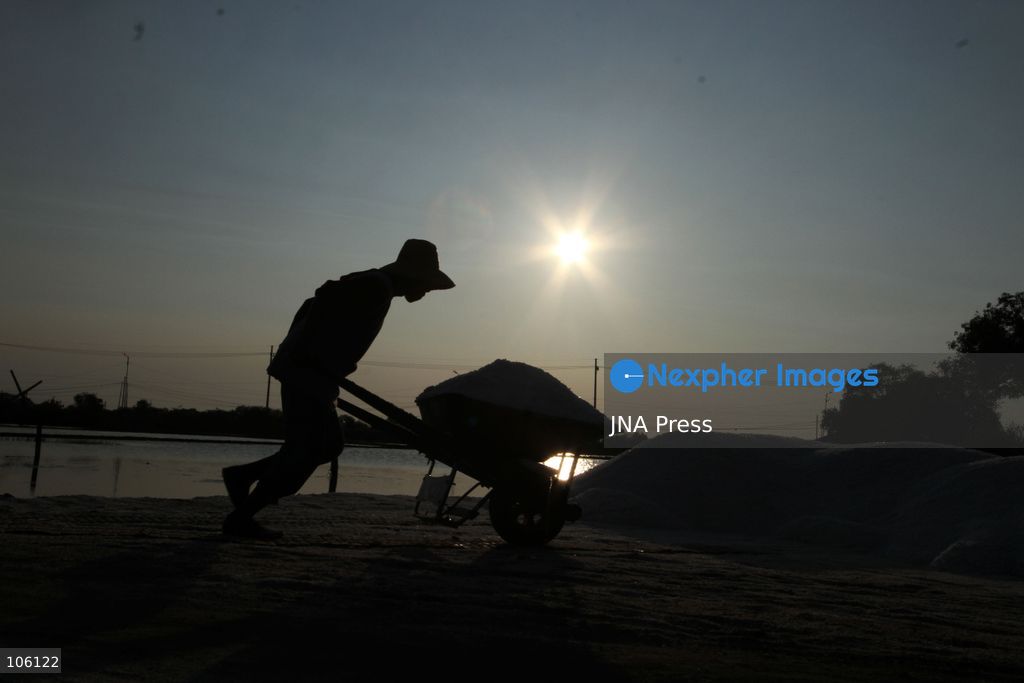 SIDOARJO, EAST JAVA, INDONESIA, OCTOBER 15, 2026: A worker harvests salt from evaporation ponds in Sedati district, Sidoarjo, East Java. Indonesia is seeking to expand domestic salt production and improve quality as part of its target to achieve salt self-sufficiency by 2027. Photo by Patrik Cahyo Lumintu / JNA Press. (Photo by Patrik Cahyo Lumintu/JNA Press via Nexpher Images)