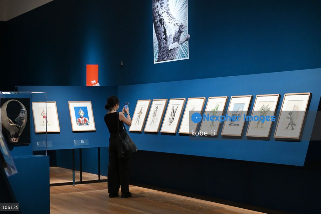 A visitor taking photo with artworks, the "Myths and Monsters: The Art of Fantasy in Asia" exhibition opening at Hong Kong’s M+. on October 15, 2026 in Hong Kong.