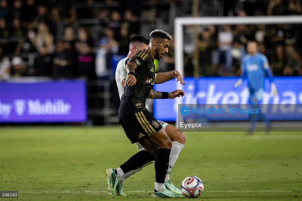 Denis Bouanga #99 of Los Angeles FC and Besard Sabovic #14 of Austin FC battle for the ball during the matchday 30 of Major League Soccer between Los Angeles Football Club and Austin FC at BMO Stadium on October 14, 2026 in Los Angeles, California. (Photo by Arturo Cordero / Eyepix Group) (Photo by Arturo Cordero / Eyepix Group/Eyepix via Nexpher Images)