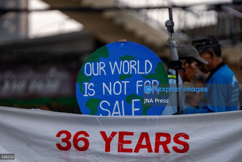 BANGKOK, THAILAND, OCTOBER 15, 2026: Members of the People’s Network Against the World Bank and IMF demonstrate at Rama IV intersection during the annual meetings of the International Monetary Fund and the World Bank Group at the Queen Sirikit National Convention Center. Demonstrators raise concerns over economic inequality, debt and the environmental impact of development policies. Protesters remain at the site during heavy rain as police maintain security around the gathering. Photo by Thanatchanont Jiraworathanakul / JNA Press (Photo by Thanatchanont Jiraworathanakul/JNA Press via Nexpher Images)