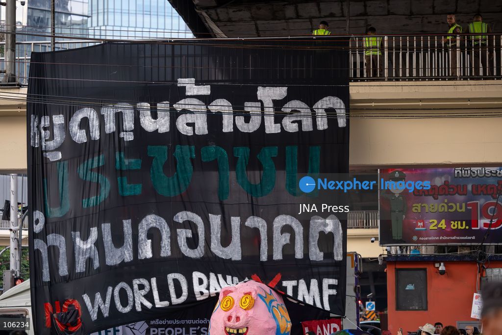 BANGKOK, THAILAND, OCTOBER 15, 2026: Members of the People’s Network Against the World Bank and IMF demonstrate at Rama IV intersection during the annual meetings of the International Monetary Fund and the World Bank Group at the Queen Sirikit National Convention Center. Demonstrators raise concerns over economic inequality, debt and the environmental impact of development policies. Protesters remain at the site during heavy rain as police maintain security around the gathering. Photo by Thanatchanont Jiraworathanakul / JNA Press (Photo by Thanatchanont Jiraworathanakul/JNA Press via Nexpher Images)