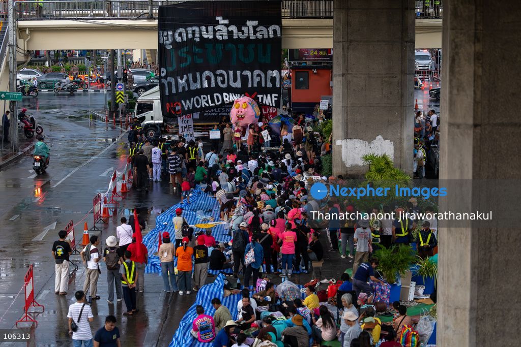 TOP PICS - BANGKOK, THAILAND — October 15, 2026 — Members of the People’s Network Against the World Bank and IMF gathered at Rama IV intersection to protest the 2026 IMF–World Bank Group Annual Meetings in Bangkok. The demonstration highlighted concerns about economic inequality, rising household debt, environmental degradation and the effects of development policies on communities across Thailand. Police blocked the demonstrators from proceeding toward the Queen Sirikit National Convention Center, where the international meetings were taking place. Protesters continued their activities and speeches despite heavy rain, while security measures remained in place around the venue. (Photo by Thanatchanont Jiraworathanakul/Nexpher Images)