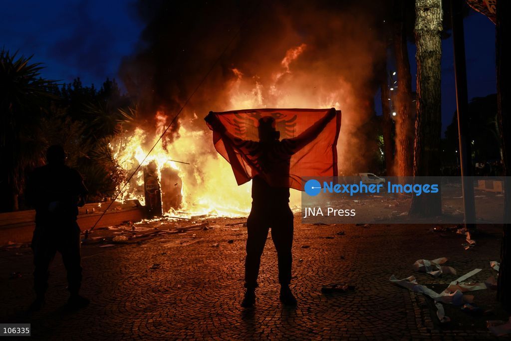 TIRANA, ALBANIA, OCTOBER 15, 2026: Students and other demonstrators protest near the Prime Minister’s Office in Tirana on the third consecutive day of anti-government demonstrations, demanding better university conditions and the resignation of Prime Minister Edi Rama. Clashes erupt between protesters and riot police, with demonstrators throwing stones, metal objects and pyrotechnics while officers respond with tear gas and water cannons. Fires are set in rubbish bins and at street kiosks, and damaged public property and debris are scattered across central Tirana. Some demonstrators are detained, while others help protesters affected by tear gas by pouring water over their faces to rinse their eyes. A bloodied female demonstrator is held on the ground by other protesters amid the confrontations. Photo by Vlasov Sulaj / JNA Press (Photo by Vlasov Sulaj/JNA Press via Nexpher Images)