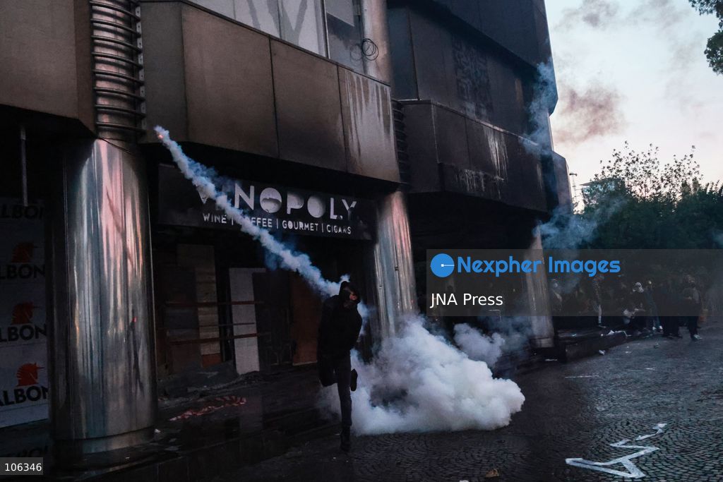 TIRANA, ALBANIA, OCTOBER 15, 2026: Students and other demonstrators protest near the Prime Minister’s Office in Tirana on the third consecutive day of anti-government demonstrations, demanding better university conditions and the resignation of Prime Minister Edi Rama. Clashes erupt between protesters and riot police, with demonstrators throwing stones, metal objects and pyrotechnics while officers respond with tear gas and water cannons. Fires are set in rubbish bins and at street kiosks, and damaged public property and debris are scattered across central Tirana. Some demonstrators are detained, while others help protesters affected by tear gas by pouring water over their faces to rinse their eyes. A bloodied female demonstrator is held on the ground by other protesters amid the confrontations. Photo by Vlasov Sulaj / JNA Press (Photo by Vlasov Sulaj/JNA Press via Nexpher Images)