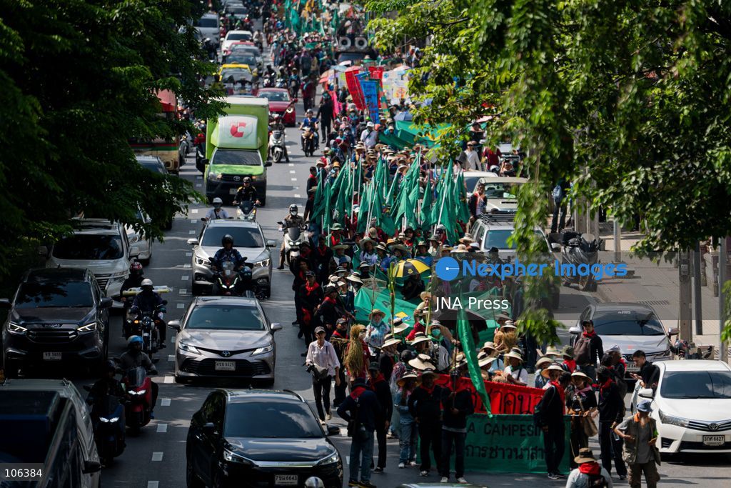 BANGKOK, THAILAND, OCTOBER 16, 2026: Members of Thailand’s Assembly of the Poor and allied community networks march towards the Queen Sirikit National Convention Center during a protest against the annual meetings of the International Monetary Fund (IMF) and the World Bank in Bangkok. Protesters representing communities affected by dams, farmers’ debt groups and other local networks carry banners and call for greater public participation in economic decision-making. They present six demands, including debt cancellation for low- and middle-income countries facing debt crises, public scrutiny of government foreign borrowing, an end to subsidies for large corporations, progressive taxation and more democratic and transparent central banks. Police maintain a heavy security presence along the protest route and around the meeting venue. Photo by Captain Jirathummanuwat / JNA Press (Photo by Captain Jirathummanuwat/JNA Press via Nexpher Images)