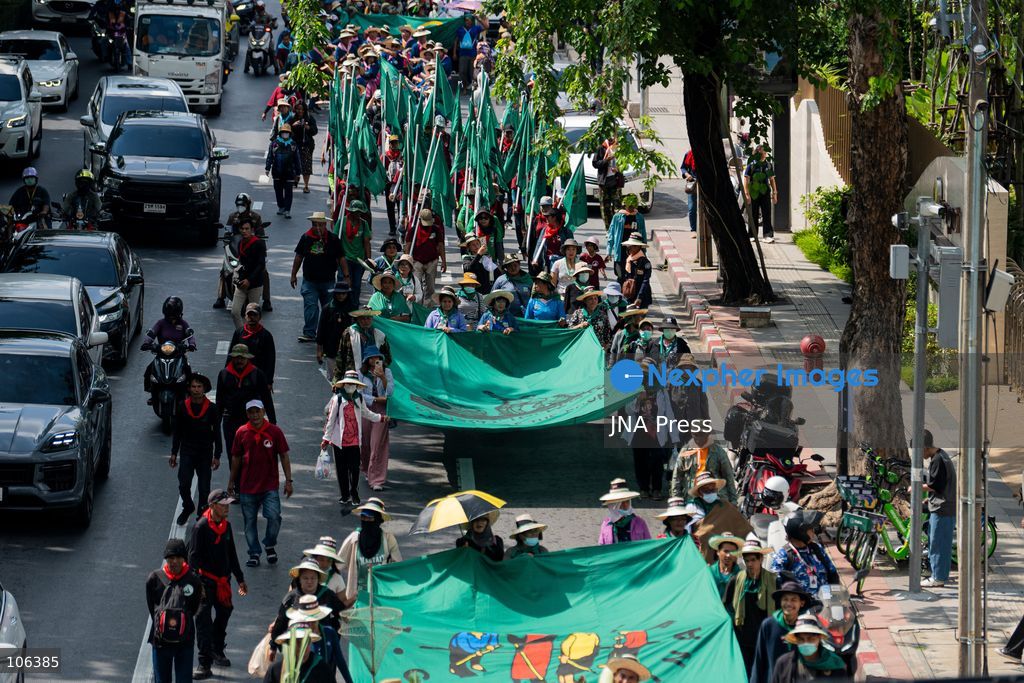 BANGKOK, THAILAND, OCTOBER 16, 2026: Members of Thailand’s Assembly of the Poor and allied community networks march towards the Queen Sirikit National Convention Center during a protest against the annual meetings of the International Monetary Fund (IMF) and the World Bank in Bangkok. Protesters representing communities affected by dams, farmers’ debt groups and other local networks carry banners and call for greater public participation in economic decision-making. They present six demands, including debt cancellation for low- and middle-income countries facing debt crises, public scrutiny of government foreign borrowing, an end to subsidies for large corporations, progressive taxation and more democratic and transparent central banks. Police maintain a heavy security presence along the protest route and around the meeting venue. Photo by Captain Jirathummanuwat / JNA Press (Photo by Captain Jirathummanuwat/JNA Press via Nexpher Images)