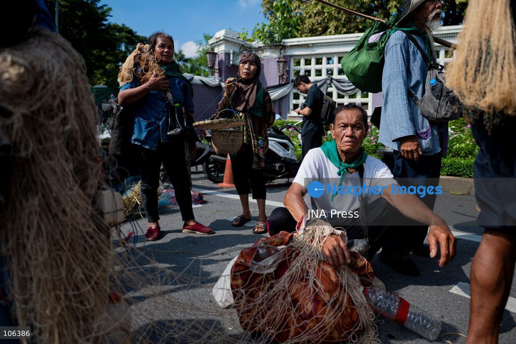 BANGKOK, THAILAND, OCTOBER 16, 2026: Members of Thailand’s Assembly of the Poor and allied community networks march towards the Queen Sirikit National Convention Center during a protest against the annual meetings of the International Monetary Fund (IMF) and the World Bank in Bangkok. Protesters representing communities affected by dams, farmers’ debt groups and other local networks carry banners and call for greater public participation in economic decision-making. They present six demands, including debt cancellation for low- and middle-income countries facing debt crises, public scrutiny of government foreign borrowing, an end to subsidies for large corporations, progressive taxation and more democratic and transparent central banks. Police maintain a heavy security presence along the protest route and around the meeting venue. Photo by Captain Jirathummanuwat / JNA Press (Photo by Captain Jirathummanuwat/JNA Press via Nexpher Images)