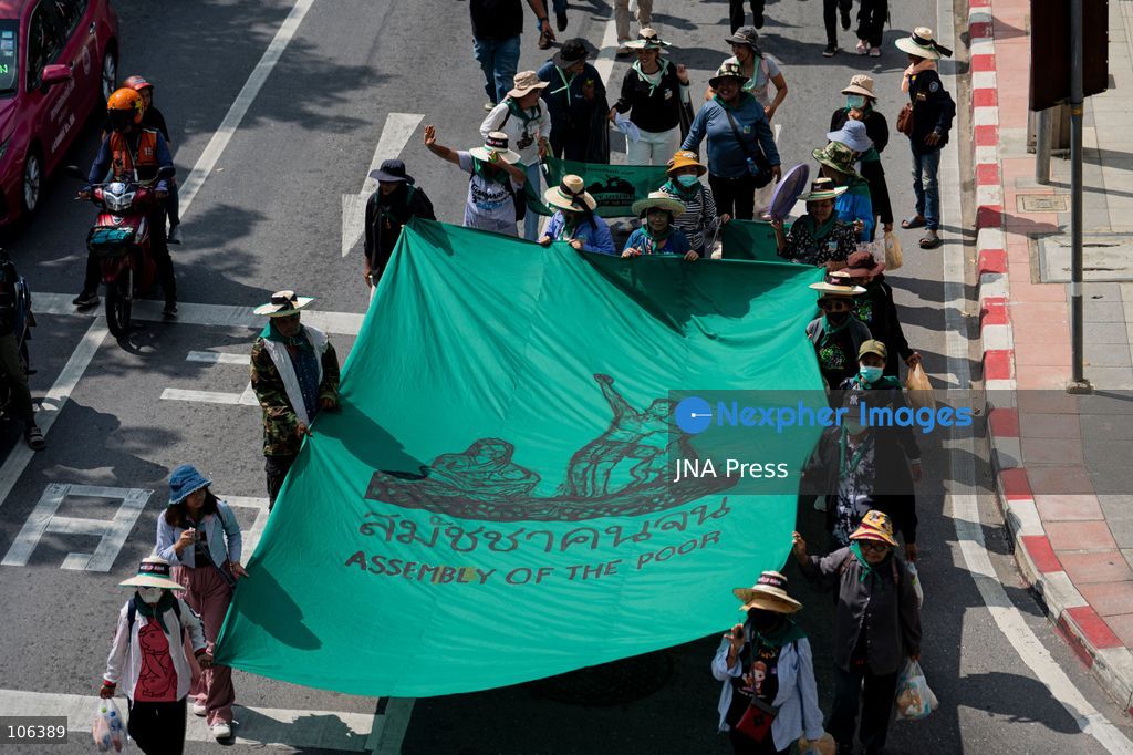 BANGKOK, THAILAND, OCTOBER 16, 2026: Members of Thailand’s Assembly of the Poor and allied community networks march towards the Queen Sirikit National Convention Center during a protest against the annual meetings of the International Monetary Fund (IMF) and the World Bank in Bangkok. Protesters representing communities affected by dams, farmers’ debt groups and other local networks carry banners and call for greater public participation in economic decision-making. They present six demands, including debt cancellation for low- and middle-income countries facing debt crises, public scrutiny of government foreign borrowing, an end to subsidies for large corporations, progressive taxation and more democratic and transparent central banks. Police maintain a heavy security presence along the protest route and around the meeting venue. Photo by Captain Jirathummanuwat / JNA Press (Photo by Captain Jirathummanuwat/JNA Press via Nexpher Images)