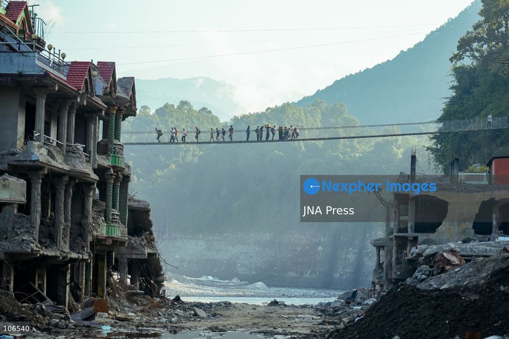 NUWAKOT, NEPAL, OCTOBER 15, 2026: People cross a newly built suspension bridge over the Trishuli River in Bidur Municipality, Nuwakot District. The footbridge restores access between communities after flooding along the Bhotekoshi–Trishuli river corridor swept away road bridges and disrupted local transport. Photo by Ambir Tolang / JNA Press. (Photo by Ambir Tolang/JNA Press via Nexpher Images)